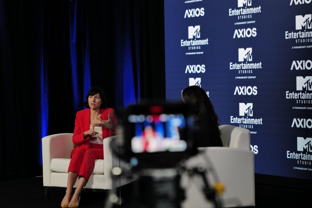 Hannah Fried speaking to an interviewer on stage at an Axios panel.