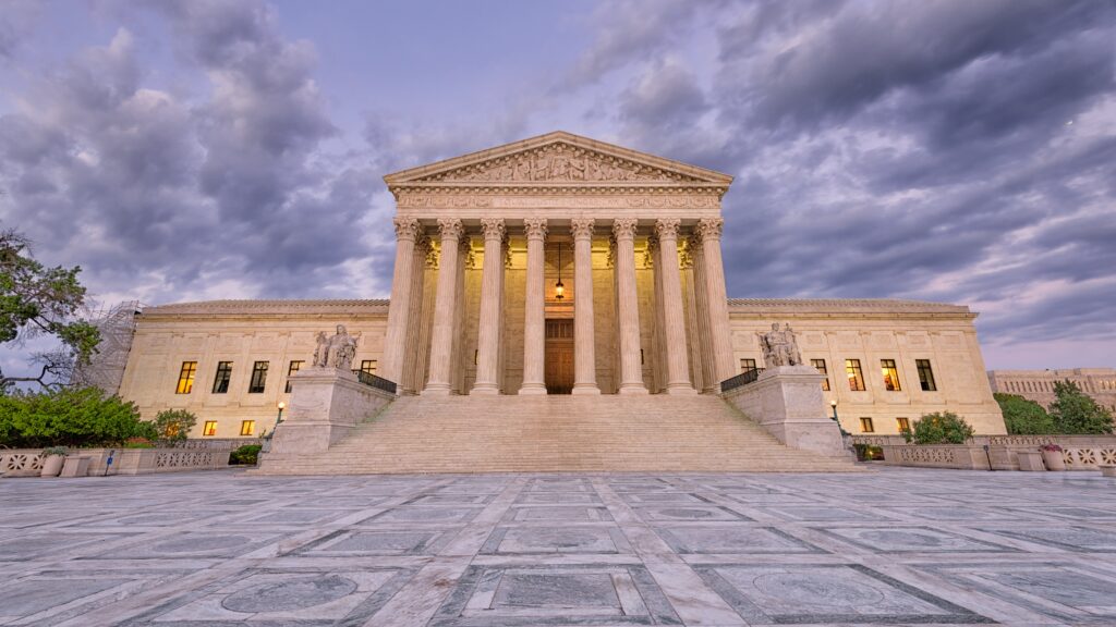 The outside of the Supreme Court building, taken at sunrise or sunset.